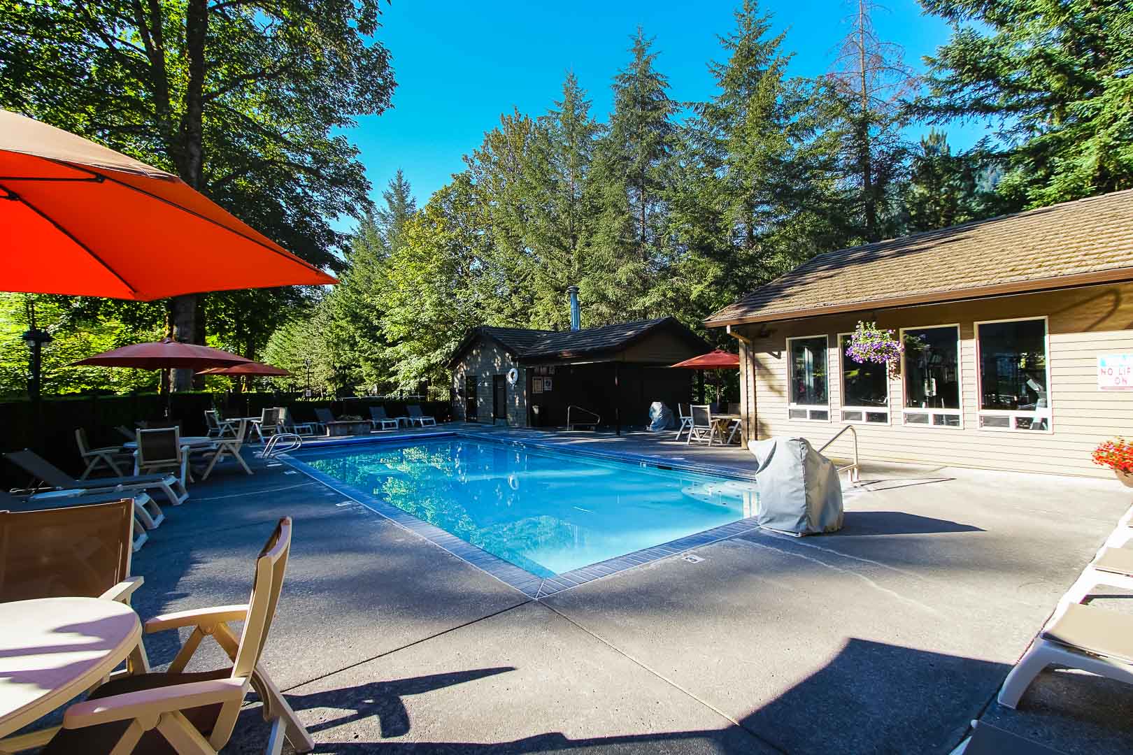 A spacious outdoor swimming pool at VRI's Whispering Woods Resort in Oregon.